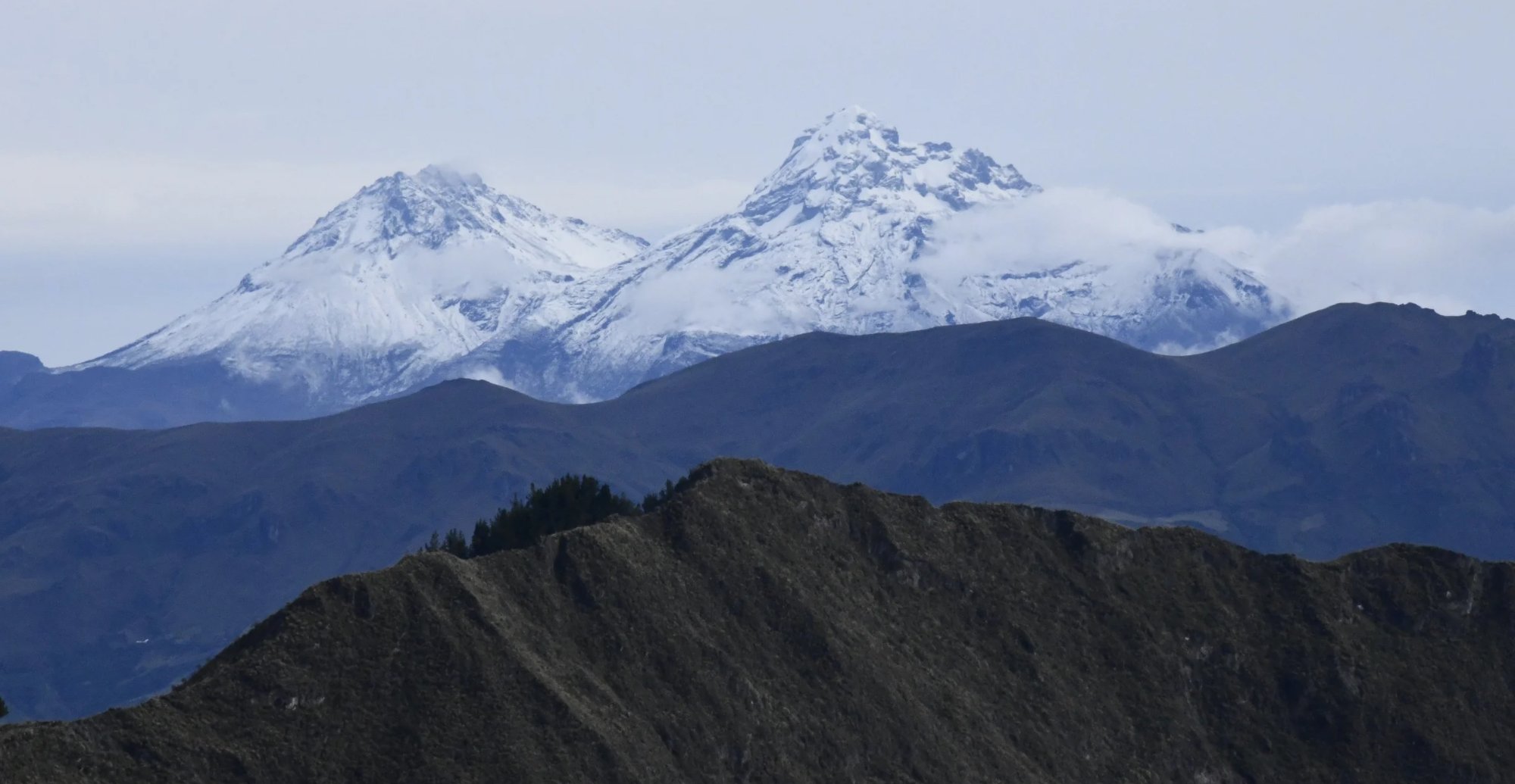 Peaks of Los Illinizas Volcanoes visible from Laguna de Quilotoa